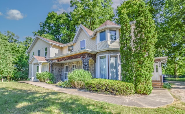500 W Chicago St, Coldwater, MI 49036 - victorian home with stone siding and a front lawn