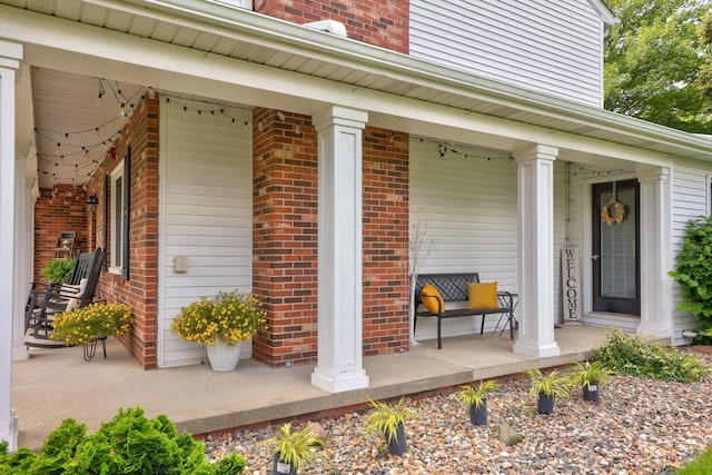 516 Zehnder Dr, Frankenmuth, MI 48734 - doorway to property with covered porch and brick siding