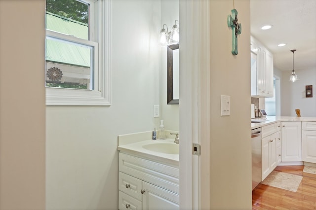 516 Zehnder Dr, Frankenmuth, MI 48734 - bathroom featuring vanity, wood finished floors, and recessed lighting