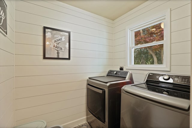 516 Zehnder Dr, Frankenmuth, MI 48734 - washroom with washing machine and clothes dryer and wood walls