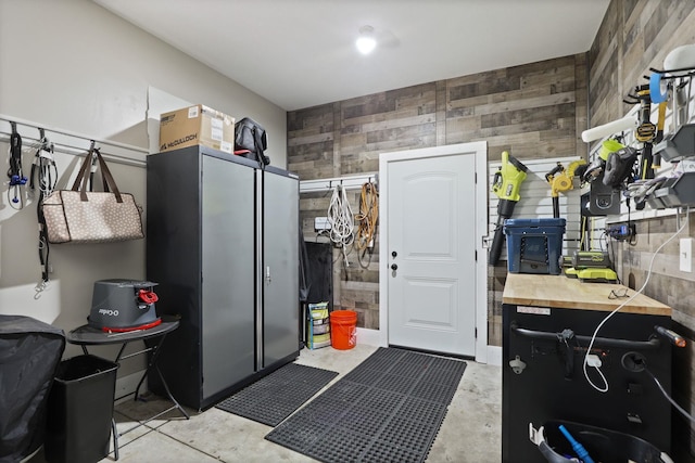 516 Zehnder Dr, Frankenmuth, MI 48734 - kitchen featuring wood counters, wooden walls, concrete floors, and an accent wall