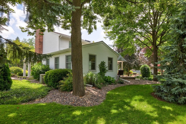 516 Zehnder Dr, Frankenmuth, MI 48734 - view of side of home with a chimney and a lawn