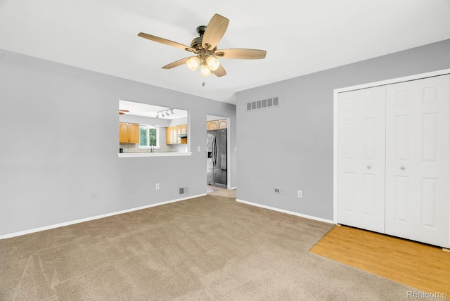 35057 Markey St, Westland, MI 48186 - unfurnished bedroom with refrigerator with ice dispenser, light carpet, and ceiling fan