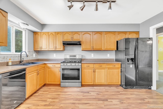 35057 Markey St, Westland, MI 48186 - kitchen featuring dishwasher, gas range, black fridge with ice dispenser, under cabinet range hood, and light wood-style flooring