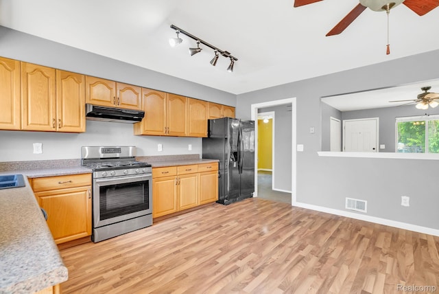 35057 Markey St, Westland, MI 48186 - kitchen featuring stainless steel gas stove, black fridge with ice dispenser, ceiling fan, under cabinet range hood, and rail lighting