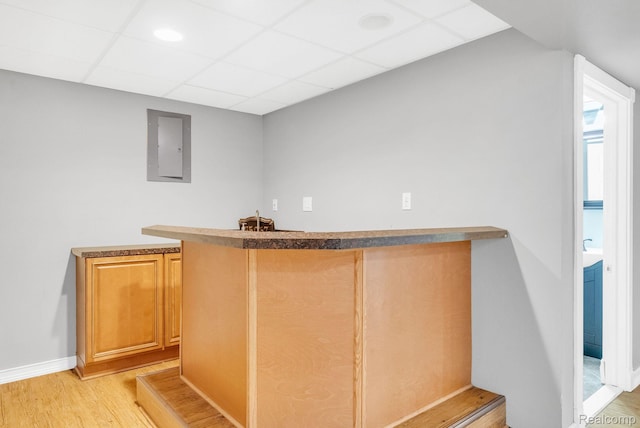 35057 Markey St, Westland, MI 48186 - indoor wet bar featuring light wood-style flooring, electric panel, and a paneled ceiling