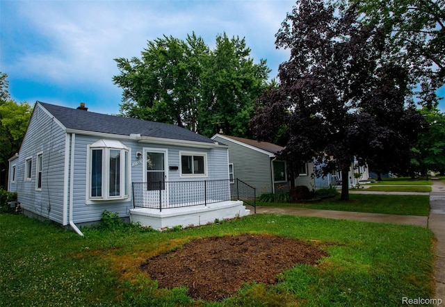 27700 Dartmouth St, Troy, MI 48071 - view of front of home featuring a front yard, a chimney, a shingled roof, and a porch