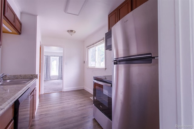 27700 Dartmouth St, Troy, MI 48071 - kitchen with appliances with stainless steel finishes, dark wood-type flooring, brown cabinets, and light stone countertops