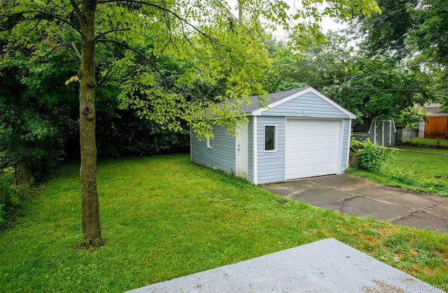 27700 Dartmouth St, Troy, MI 48071 - view of yard with a detached garage, an outbuilding, and concrete driveway