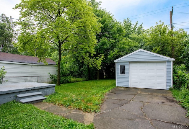 27700 Dartmouth St, Troy, MI 48071 - view of grassy yard with an outdoor structure, asphalt driveway, and a detached garage