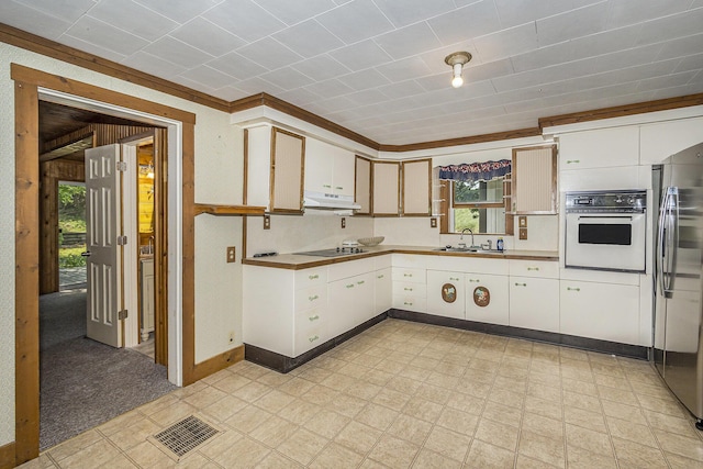 7035 W Filmore Rd, Mears, MI 49436 - kitchen featuring oven, freestanding refrigerator, light floors, under cabinet range hood, and white cabinets