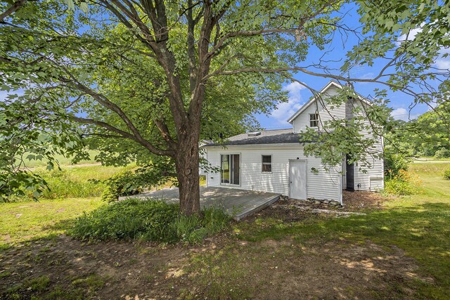 7035 W Filmore Rd, Mears, MI 49436 - back of house featuring a deck and a lawn