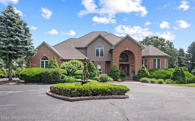 519 Hawksmoore Dr, Clarkston, MI 48348 - traditional-style home with brick siding and curved driveway