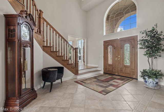 519 Hawksmoore Dr, Clarkston, MI 48348 - foyer entrance featuring plenty of natural light, a high ceiling, stairway, and light tile patterned floors