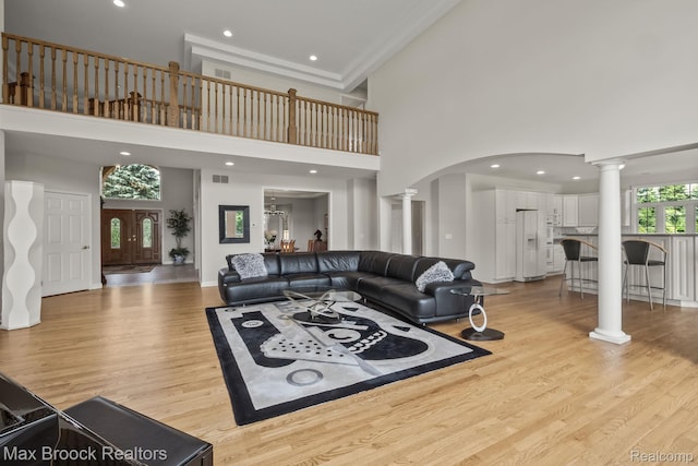 519 Hawksmoore Dr, Clarkston, MI 48348 - living area with decorative columns, a high ceiling, light wood-type flooring, arched walkways, and recessed lighting