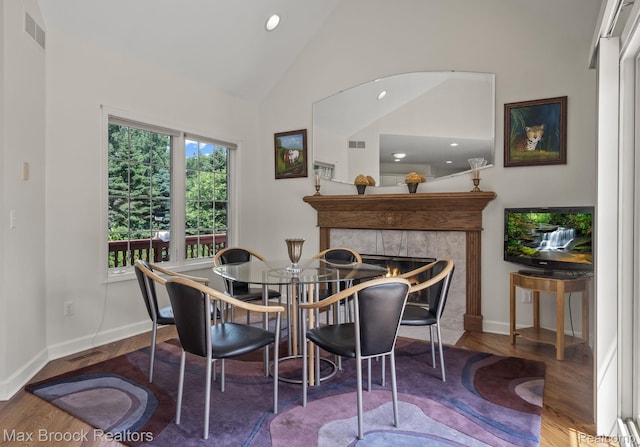 519 Hawksmoore Dr, Clarkston, MI 48348 - dining space with wood finished floors, a tiled fireplace, recessed lighting, and high vaulted ceiling