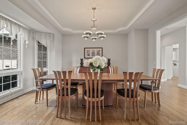 519 Hawksmoore Dr, Clarkston, MI 48348 - dining space featuring a tray ceiling, a chandelier, and light wood finished floors