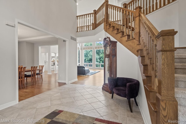 519 Hawksmoore Dr, Clarkston, MI 48348 - stairway featuring tile patterned flooring and a towering ceiling