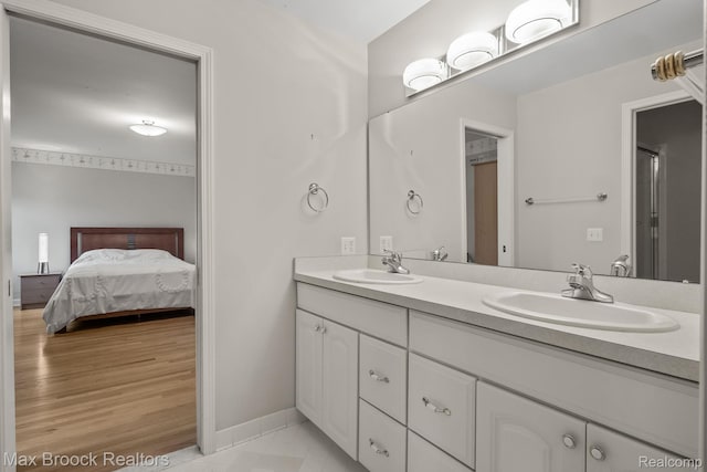 519 Hawksmoore Dr, Clarkston, MI 48348 - ensuite bathroom featuring double vanity and baseboards