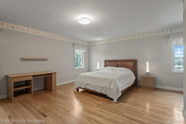 519 Hawksmoore Dr, Clarkston, MI 48348 - bedroom with multiple windows and light wood-style flooring