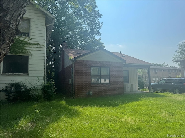 17416 Bentler St, Detroit, MI 48219 - view of home's exterior featuring brick siding and a yard