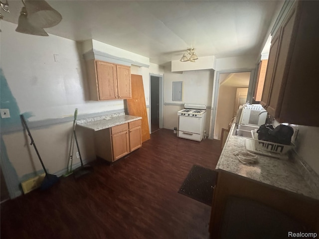 17416 Bentler St, Detroit, MI 48219 - kitchen with dark wood finished floors, white gas stove, light countertops, and electric panel