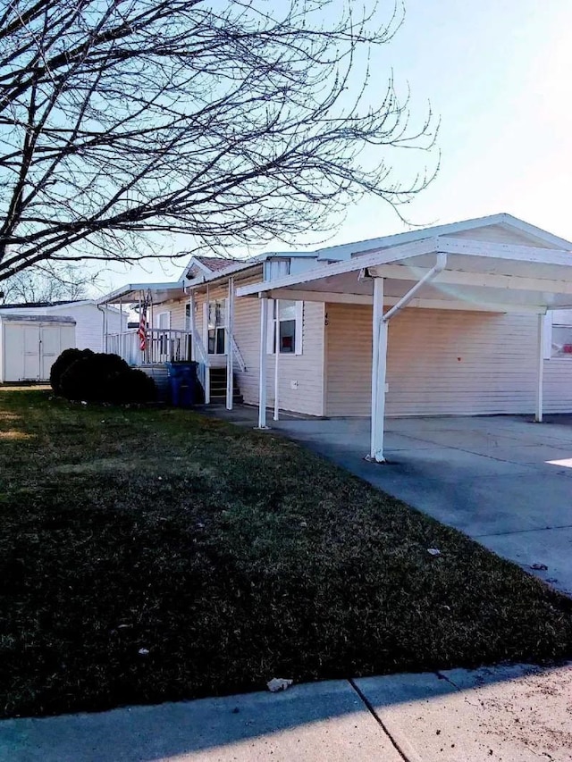 737 Walton Rd, Mount Morris, MI 48768 - view of front of house with an attached carport, driveway, and a storage shed