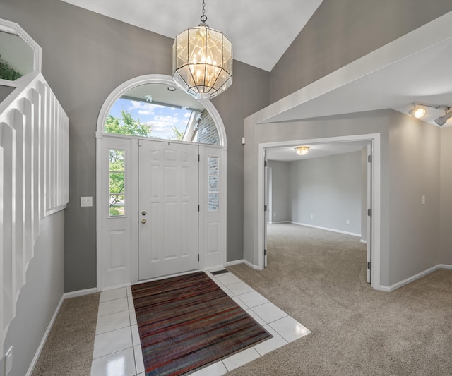 2418 Meadowridge Ct, Ann Arbor, MI 48105 - foyer featuring light carpet, a chandelier, light tile patterned flooring, and high vaulted ceiling