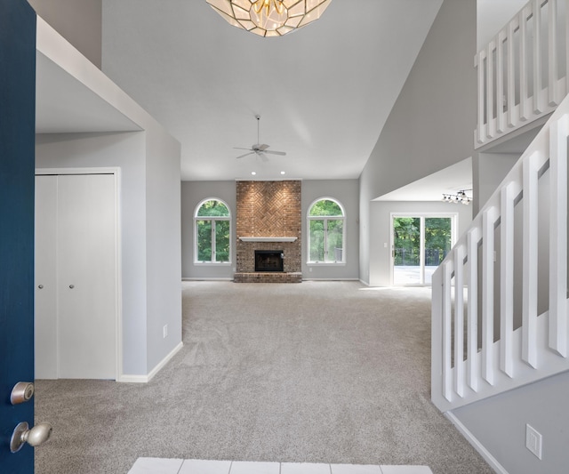 2418 Meadowridge Ct, Ann Arbor, MI 48105 - unfurnished living room with carpet, a fireplace, ceiling fan, and high vaulted ceiling