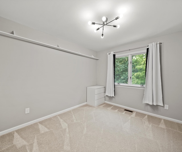 2418 Meadowridge Ct, Ann Arbor, MI 48105 - spare room with a chandelier and carpet floors