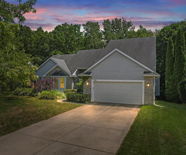 2418 Meadowridge Ct, Ann Arbor, MI 48105 - view of front of house featuring driveway, a garage, a front lawn, and brick siding