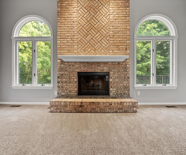 2418 Meadowridge Ct, Ann Arbor, MI 48105 - unfurnished living room with carpet, a brick fireplace, and healthy amount of natural light