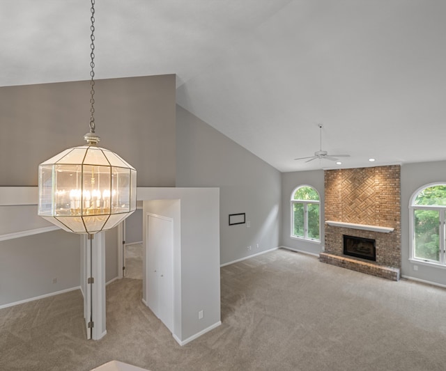 2418 Meadowridge Ct, Ann Arbor, MI 48105 - unfurnished living room featuring carpet floors, ceiling fan, a brick fireplace, a chandelier, and recessed lighting