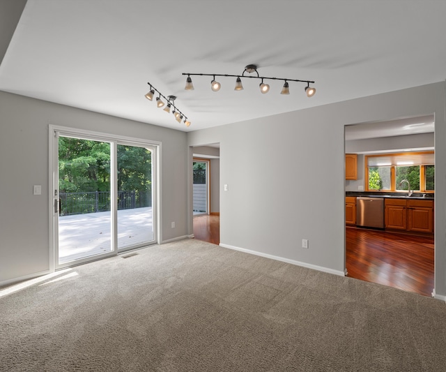 2418 Meadowridge Ct, Ann Arbor, MI 48105 - spare room with dark colored carpet, healthy amount of natural light, and track lighting