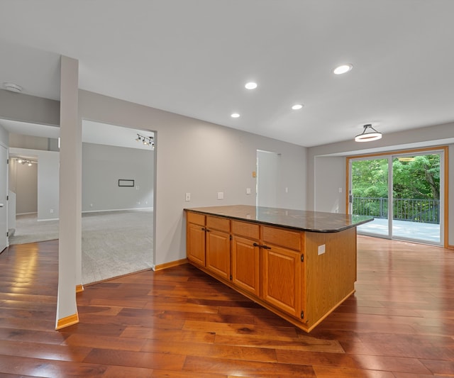 2418 Meadowridge Ct, Ann Arbor, MI 48105 - kitchen featuring a peninsula, dark wood-style floors, recessed lighting, and dark stone counters
