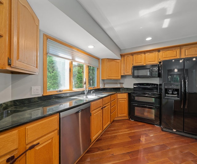 2418 Meadowridge Ct, Ann Arbor, MI 48105 - kitchen featuring black appliances, dark wood finished floors, recessed lighting, and dark stone countertops