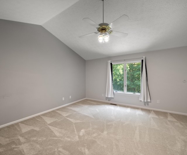 2418 Meadowridge Ct, Ann Arbor, MI 48105 - unfurnished room with lofted ceiling, carpet floors, ceiling fan, and a textured ceiling