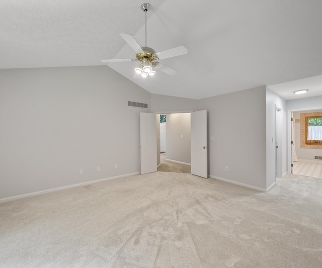 2418 Meadowridge Ct, Ann Arbor, MI 48105 - spare room with light colored carpet, ceiling fan, and lofted ceiling