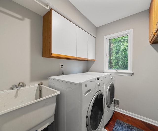 2418 Meadowridge Ct, Ann Arbor, MI 48105 - washroom with cabinet space, washer and clothes dryer, and dark wood-style floors