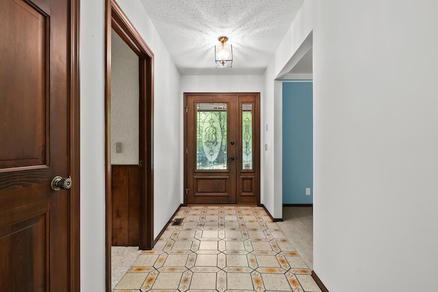 1130 W G Ave, Kalamazoo, MI 49009 - foyer featuring a textured ceiling and inlaid floor details