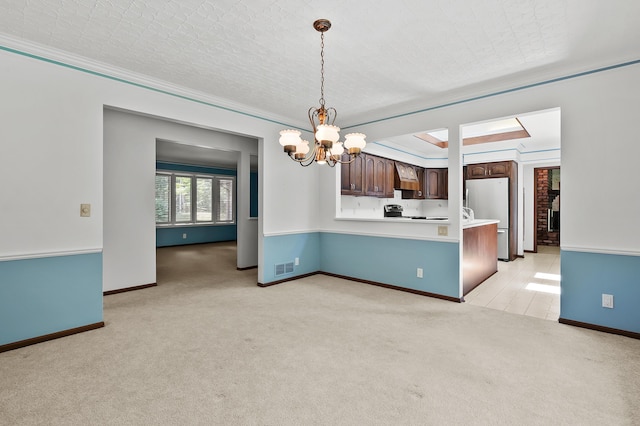 1130 W G Ave, Kalamazoo, MI 49009 - unfurnished dining area with light carpet, a chandelier, and ornamental molding