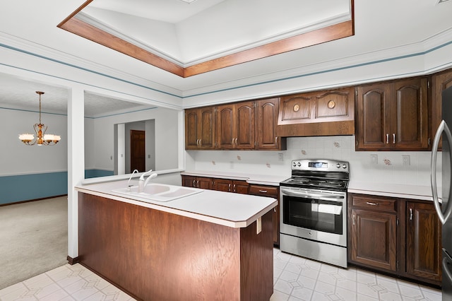 1130 W G Ave, Kalamazoo, MI 49009 - kitchen featuring appliances with stainless steel finishes, light countertops, a chandelier, dark brown cabinets, and backsplash