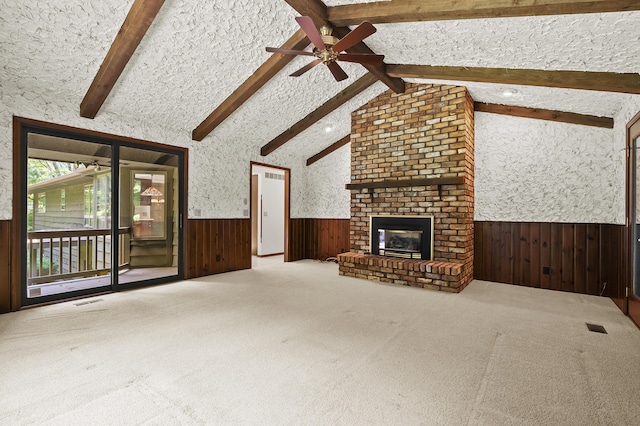 1130 W G Ave, Kalamazoo, MI 49009 - unfurnished living room with a wainscoted wall, a ceiling fan, wood walls, carpet, and a fireplace
