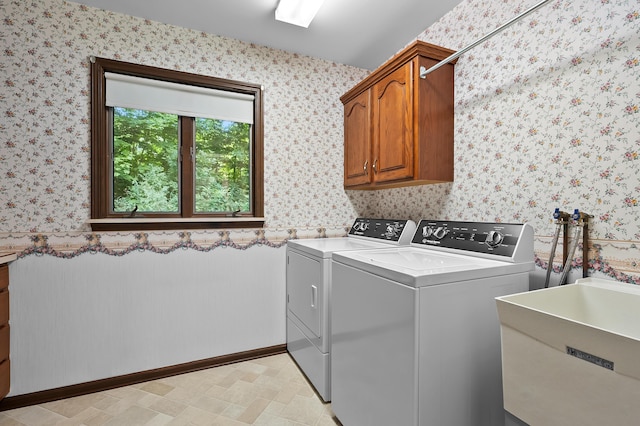 1130 W G Ave, Kalamazoo, MI 49009 - washroom featuring wallpapered walls, washer and clothes dryer, and cabinet space