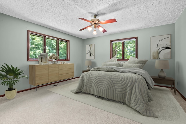 1130 W G Ave, Kalamazoo, MI 49009 - bedroom with light carpet, a textured ceiling, and ceiling fan