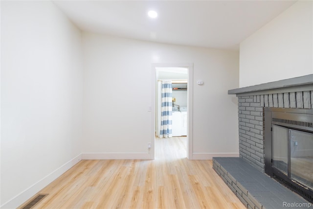 8614 Lake Rd, Grosse Ile, MI 48138 - unfurnished living room featuring wood finished floors, a fireplace, washer / clothes dryer, and recessed lighting
