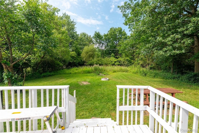8614 Lake Rd, Grosse Ile, MI 48138 - view of green lawn with a deck and view of wooded area
