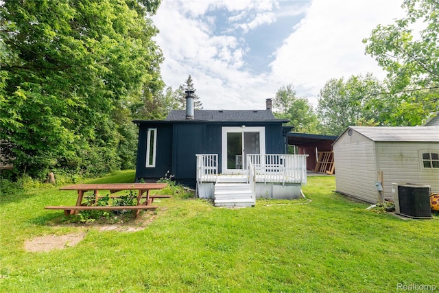 8614 Lake Rd, Grosse Ile, MI 48138 - back of property featuring a deck, a lawn, a chimney, and a shed
