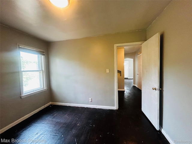 22510 Frisbee St, Detroit, MI 48219 - spare room with baseboards and dark wood-style floors