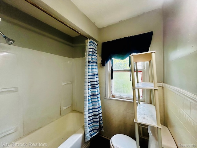 22510 Frisbee St, Detroit, MI 48219 - bathroom featuring tile walls, shower / tub combo, and wainscoting